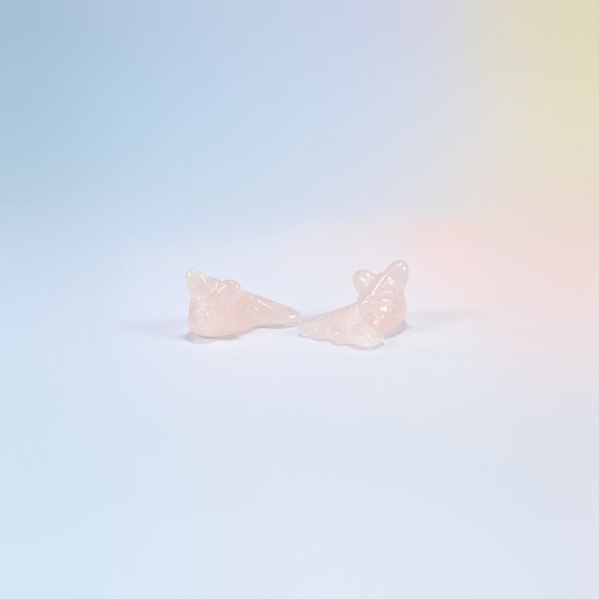 Two 1.5 inch natural rose quartz goldfish carvings, light pink with carved scales