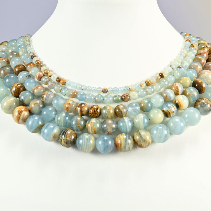 Blue Calcite smooth round beads layered as a collar, several strands stepping from 4mm up to 12mm