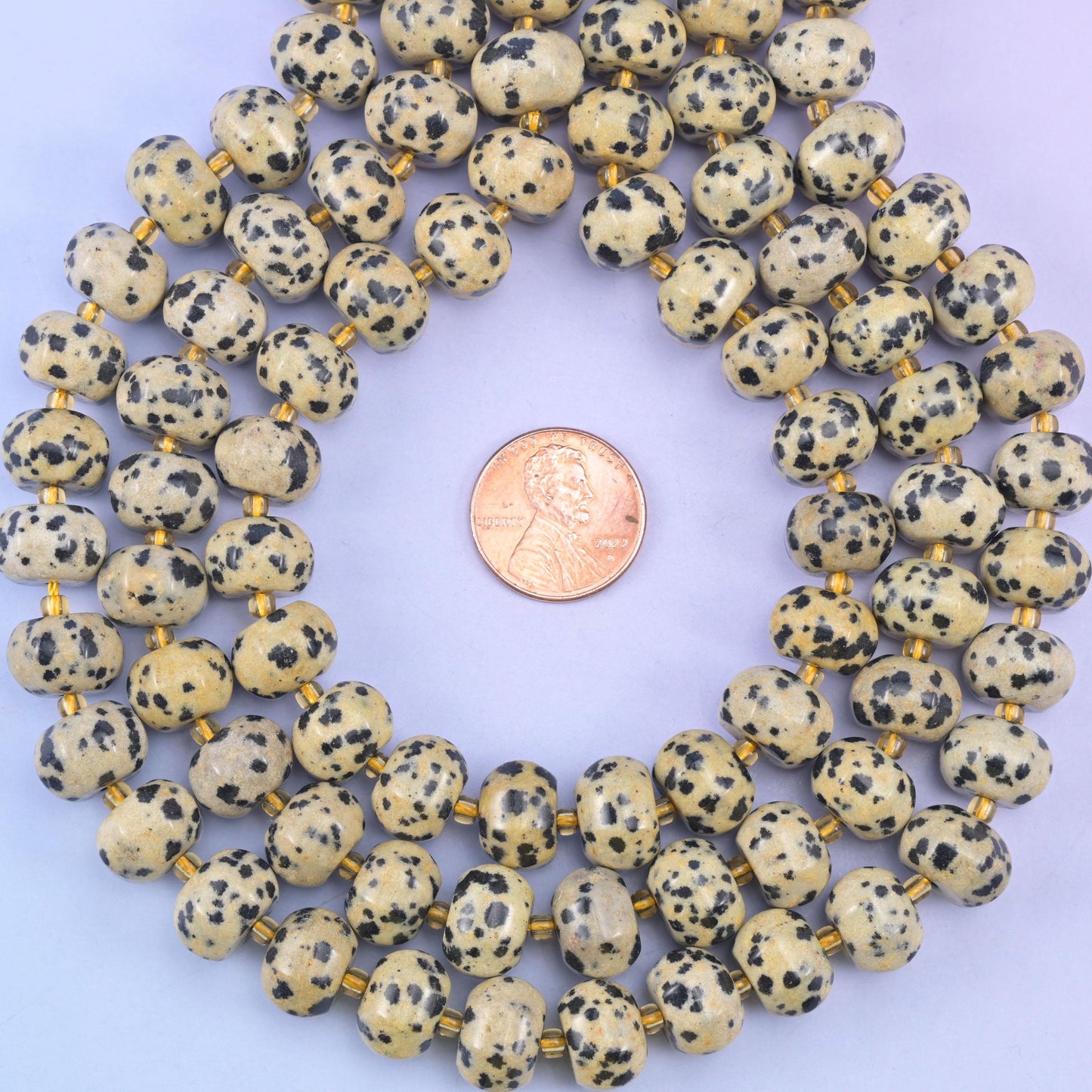Dalmatian jasper smooth pumpkin beads in cream and beige with playful black spots