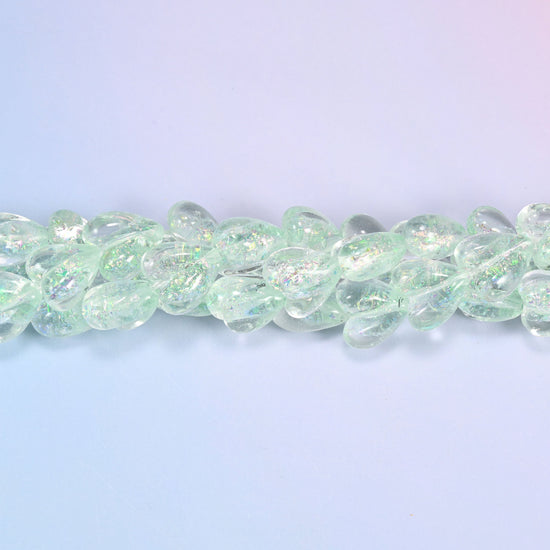 Clear pale mint glass hearts carrying a fine iridescent shimmer that shifts towards silver and pale gold