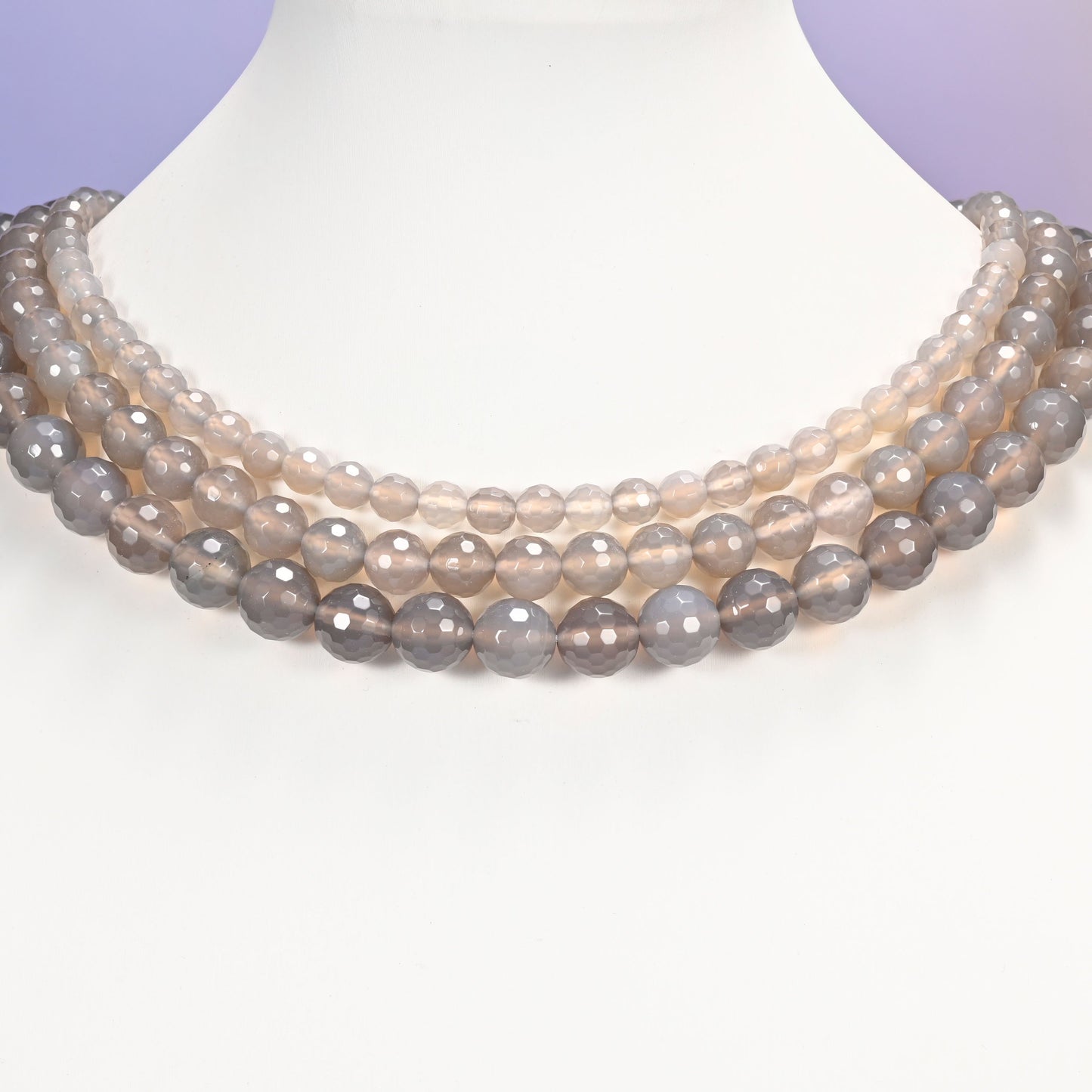Close-up of gray agate round beads, showing the faceted finish and natural gray tone.