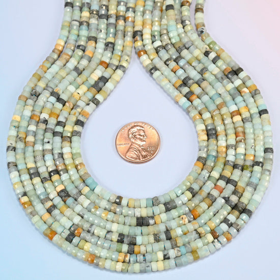 Multi-color amazonite faceted heishi disc strands formed into a teardrop loop around a US penny for scale