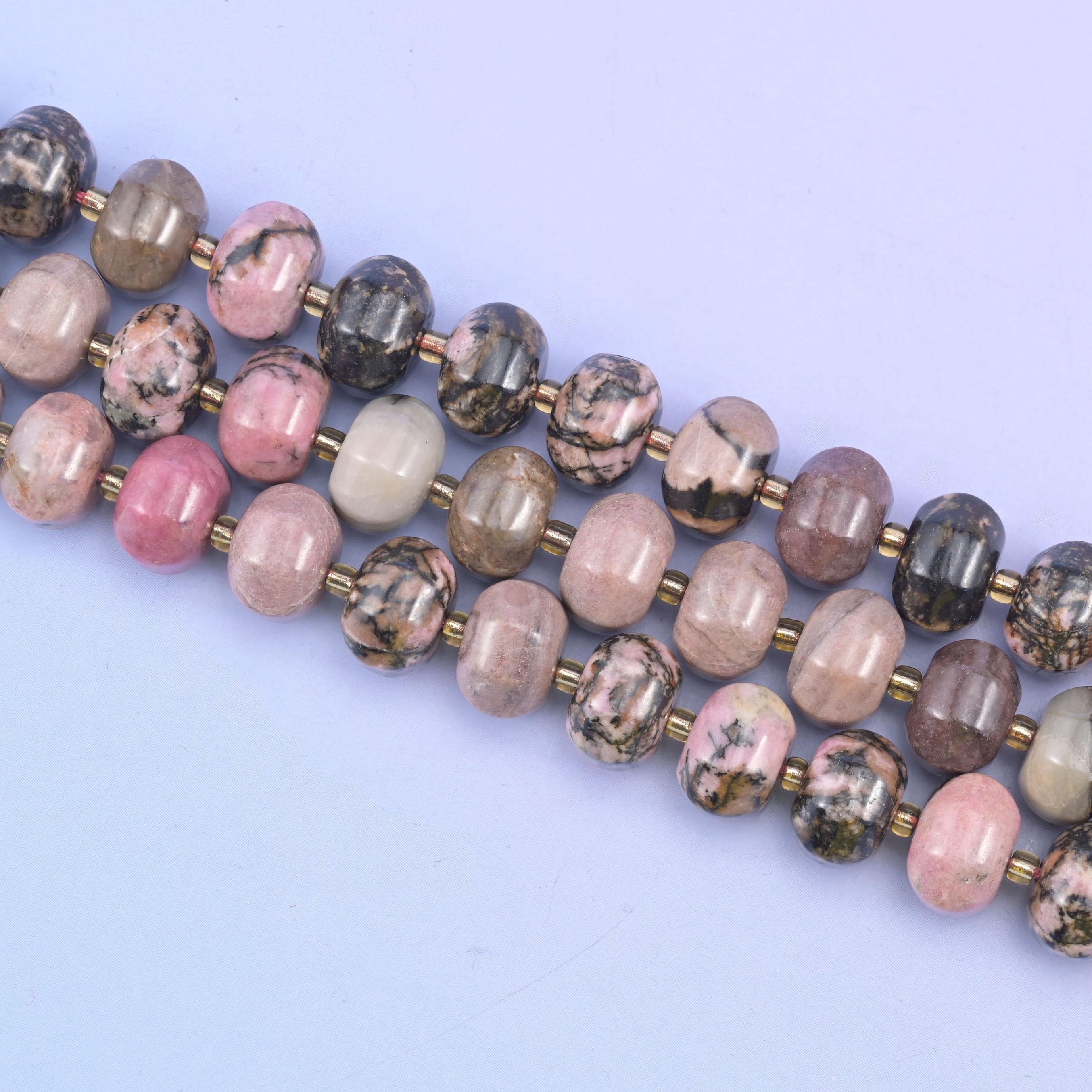 Rhodonite beads in soft pink with striking black matrix veining