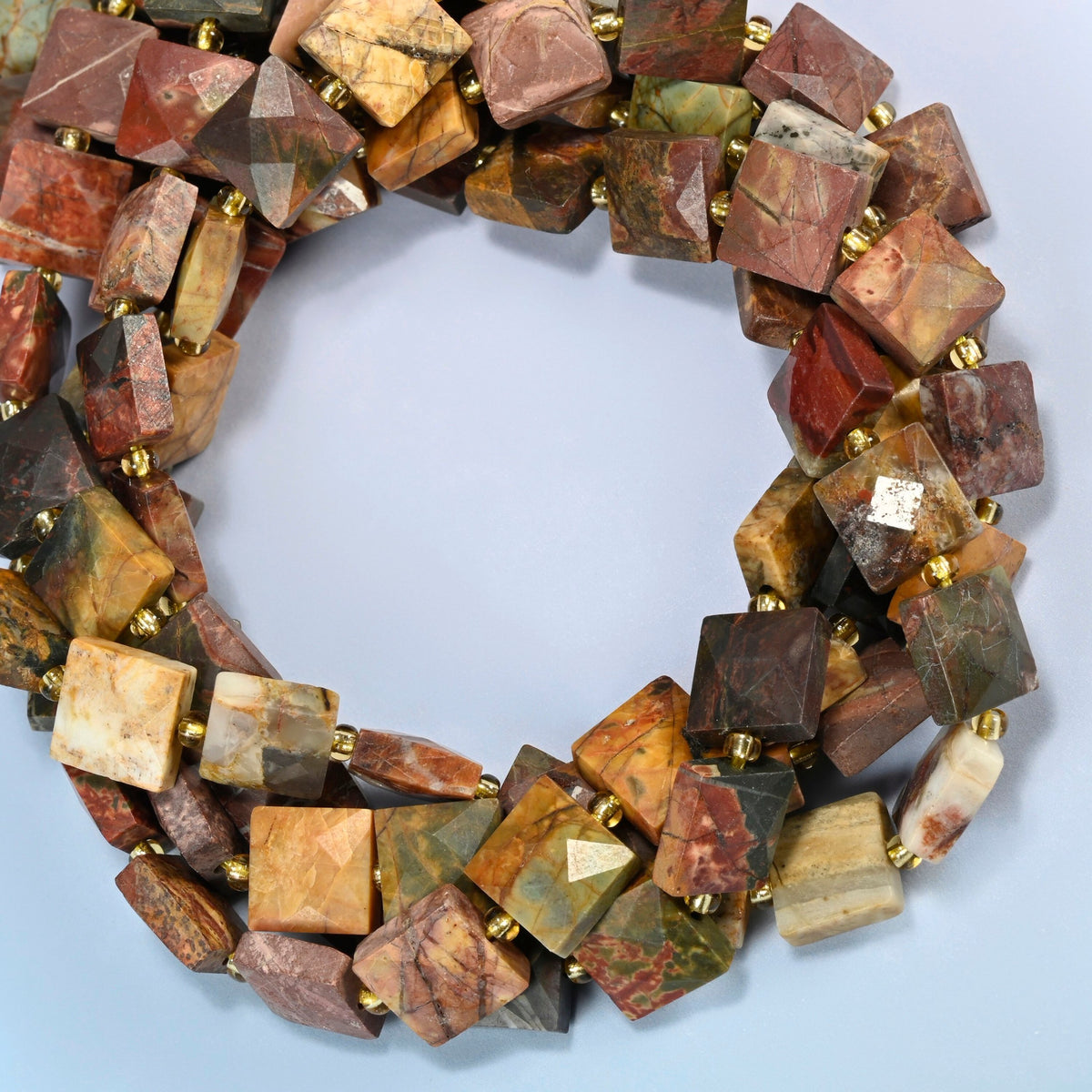 Natural red howlite faceted flat square beads coiled into overlapping loops, whole strands of earthy multicolor stone
