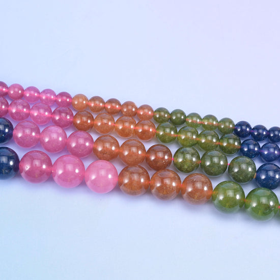 Dyed jade round beads in bright rose pink, mossy olive green, terracotta copper and deep navy blue