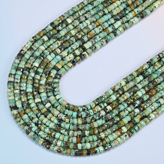 African howlite faceted heishi disc beads in several strands curved into a wide U, turquoise green stone with dark matrix