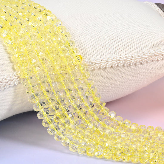 Bright buttercup yellow transparent faceted rondelle glass beads that shade toward clear at the rims