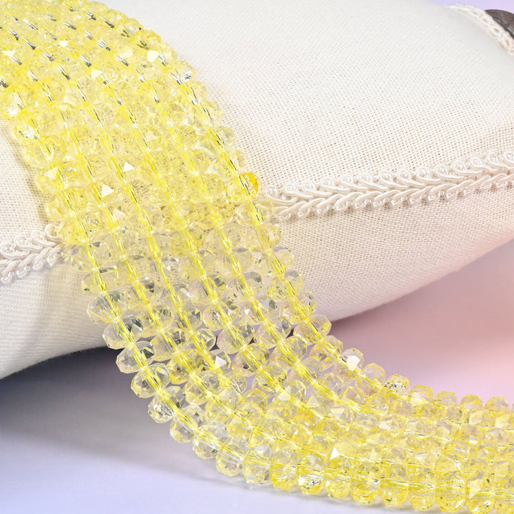 Bright buttercup yellow transparent faceted rondelle glass beads that shade toward clear at the rims