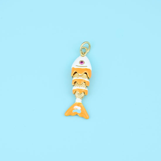 A jointed fish whose body segments swing as it hangs, finished in warm orange and white enamel over gold with a tiny pink…