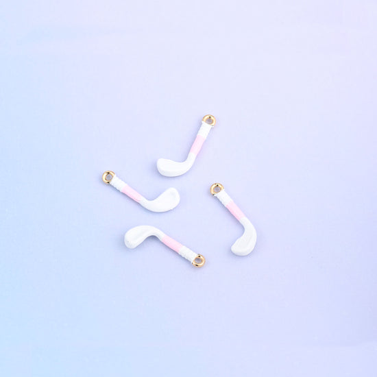 Four white golf club charms with light pink grips.