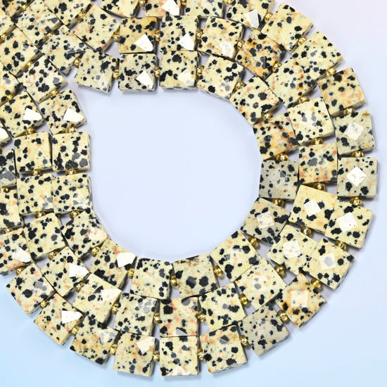Dalmatian jasper faceted flat square beads curved into an open loop, cream and black spotted stone