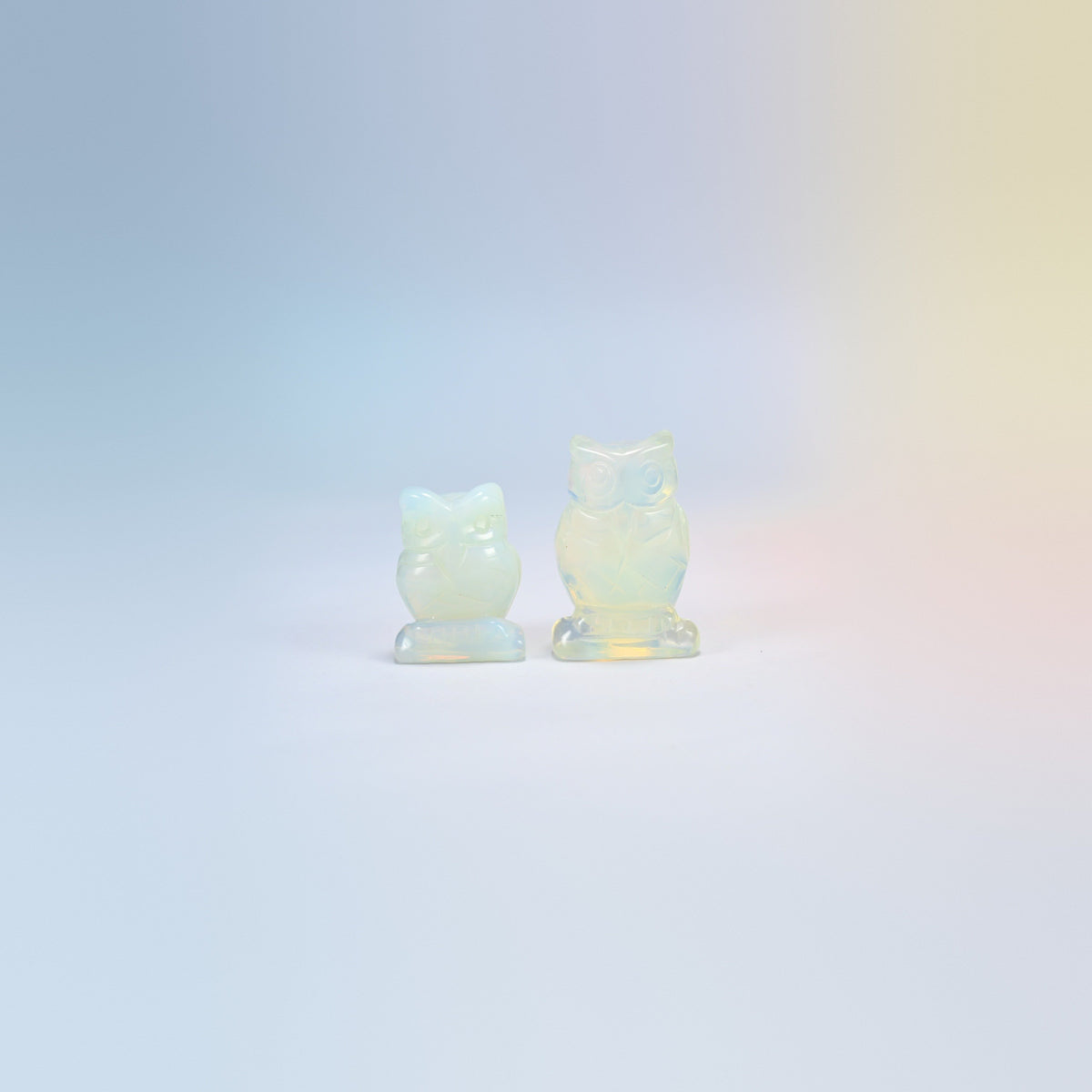 Owl crystal carving in opalite, milky white man-made glass with a blue glow