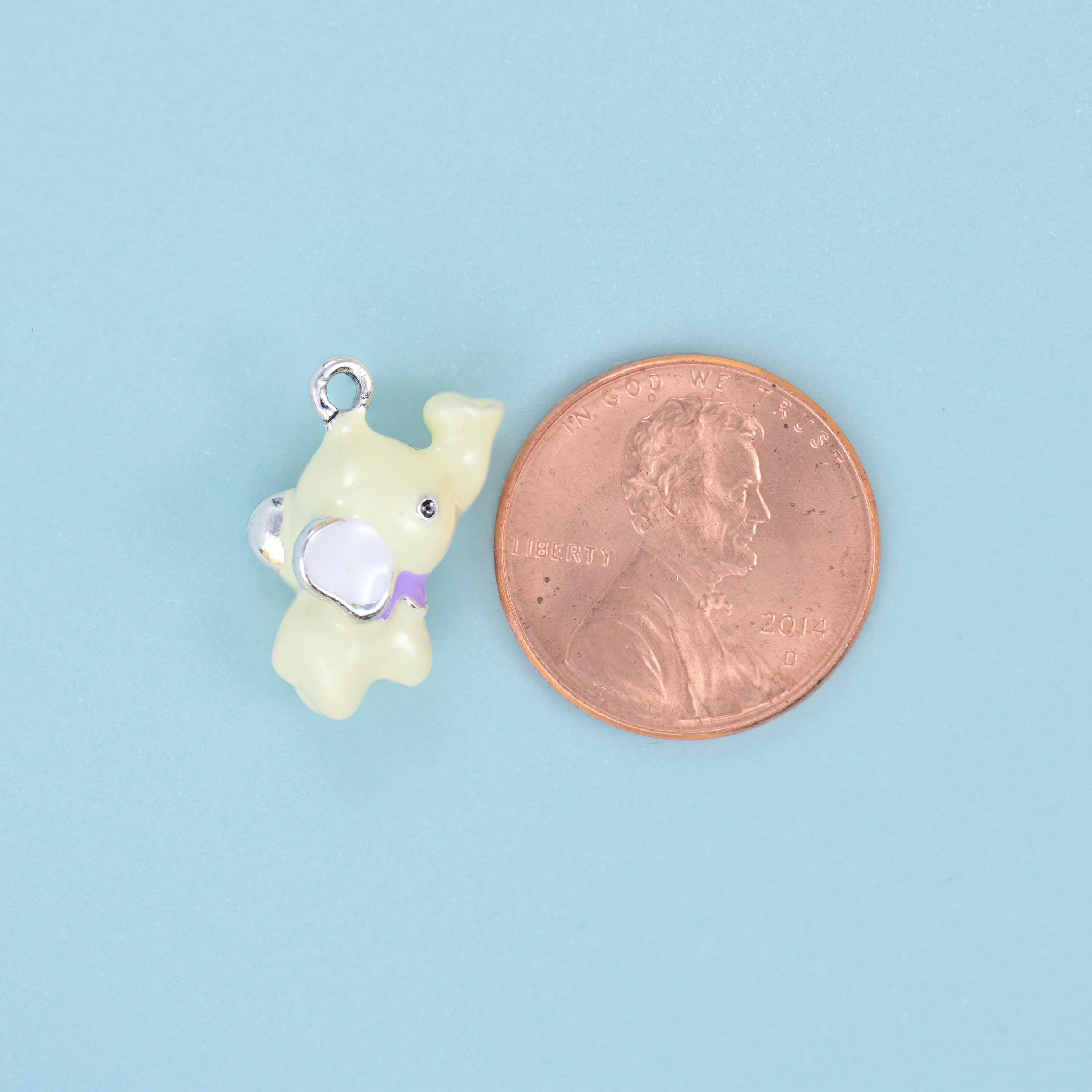 A chubby little elephant modelled fully in the round rather than stamped flat — glossy pastel enamel in baby pink, powder…