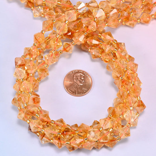 Citrine bicone beads coiled into a round ring, 8mm beads with gold-tone spacers throughout.