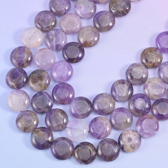 Amethyst coin strands sweeping in a curve, clear violet beside cloudy grey