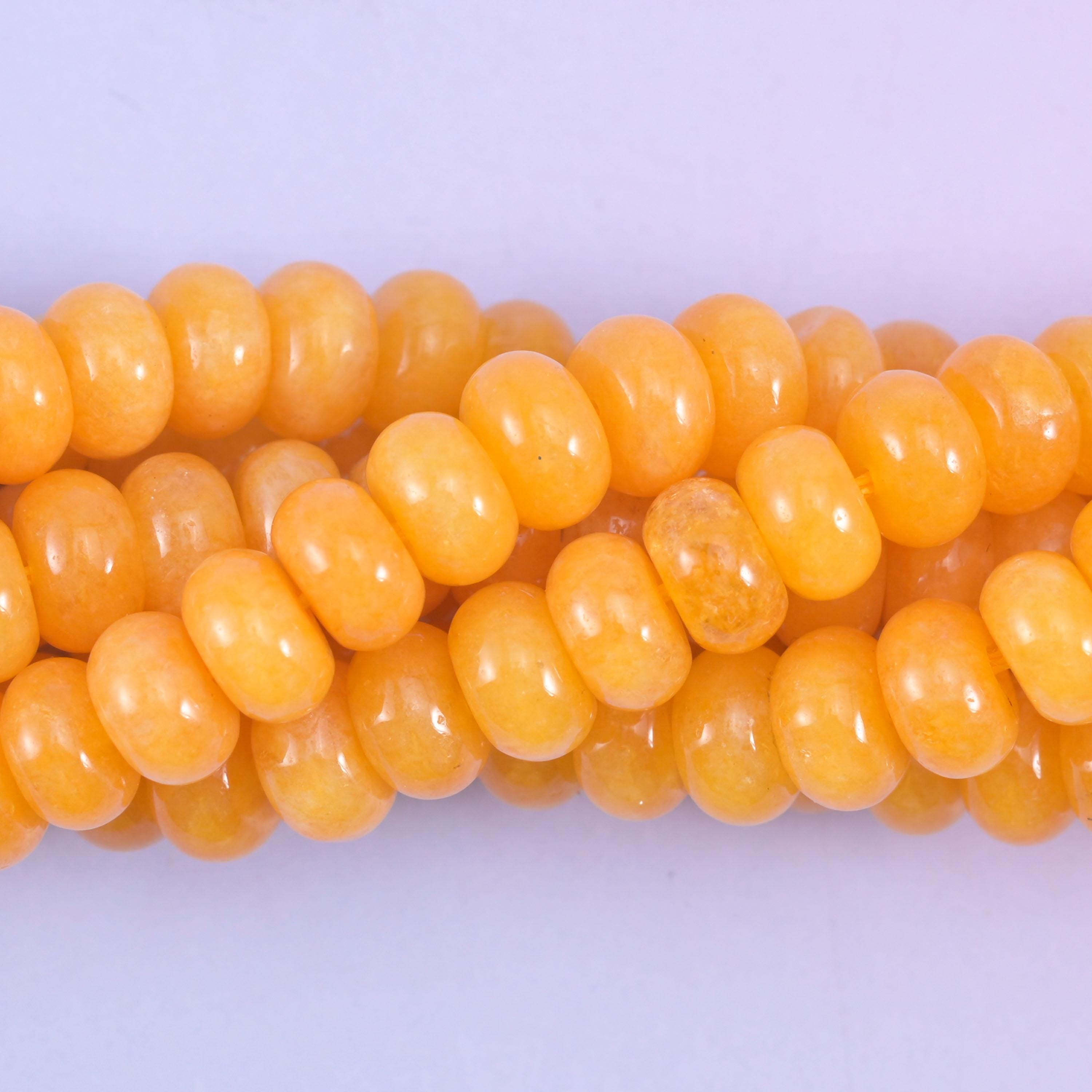 Smooth rondelle cut dyed jade beads with a polished surface
