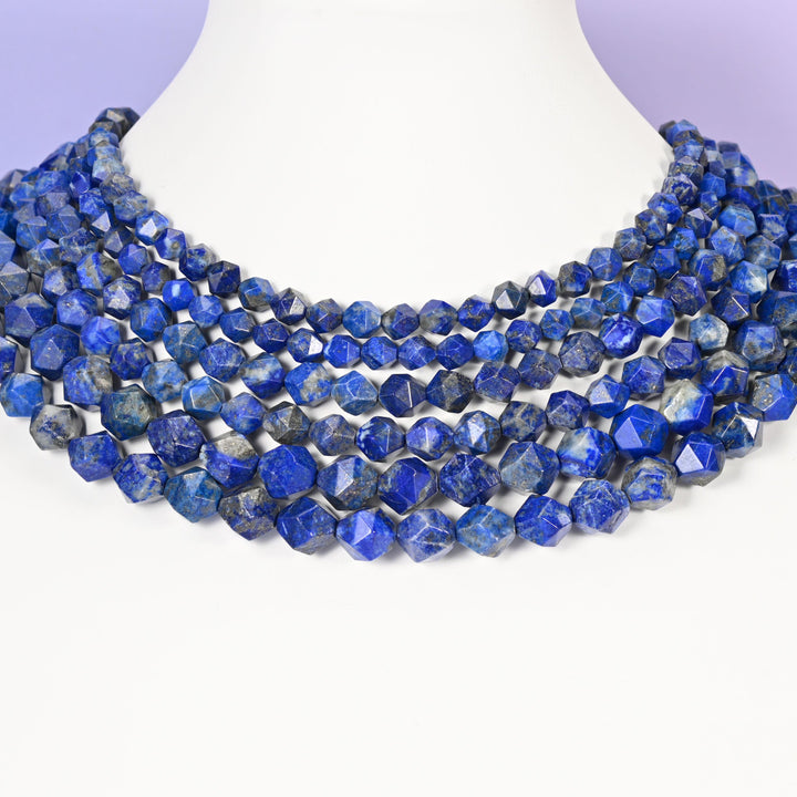 Blue Lapis Lazuli star cut beads looped around a white neck form, several strands sitting together as a collar