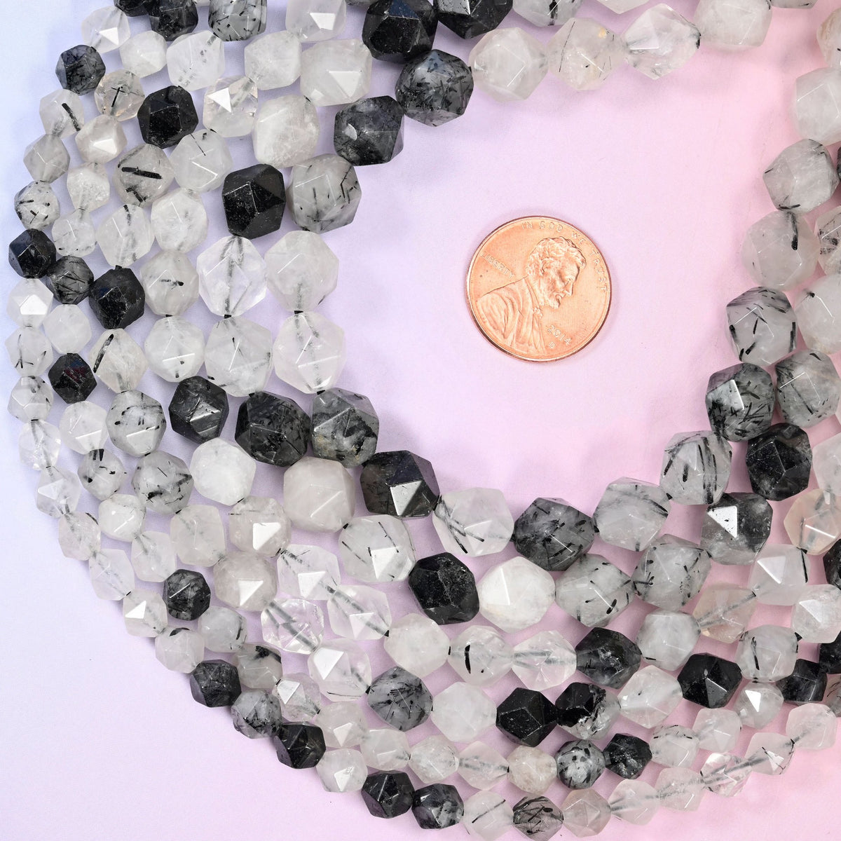 Black Rutilated Quartz beads, approximately 38 to 63 per strand.