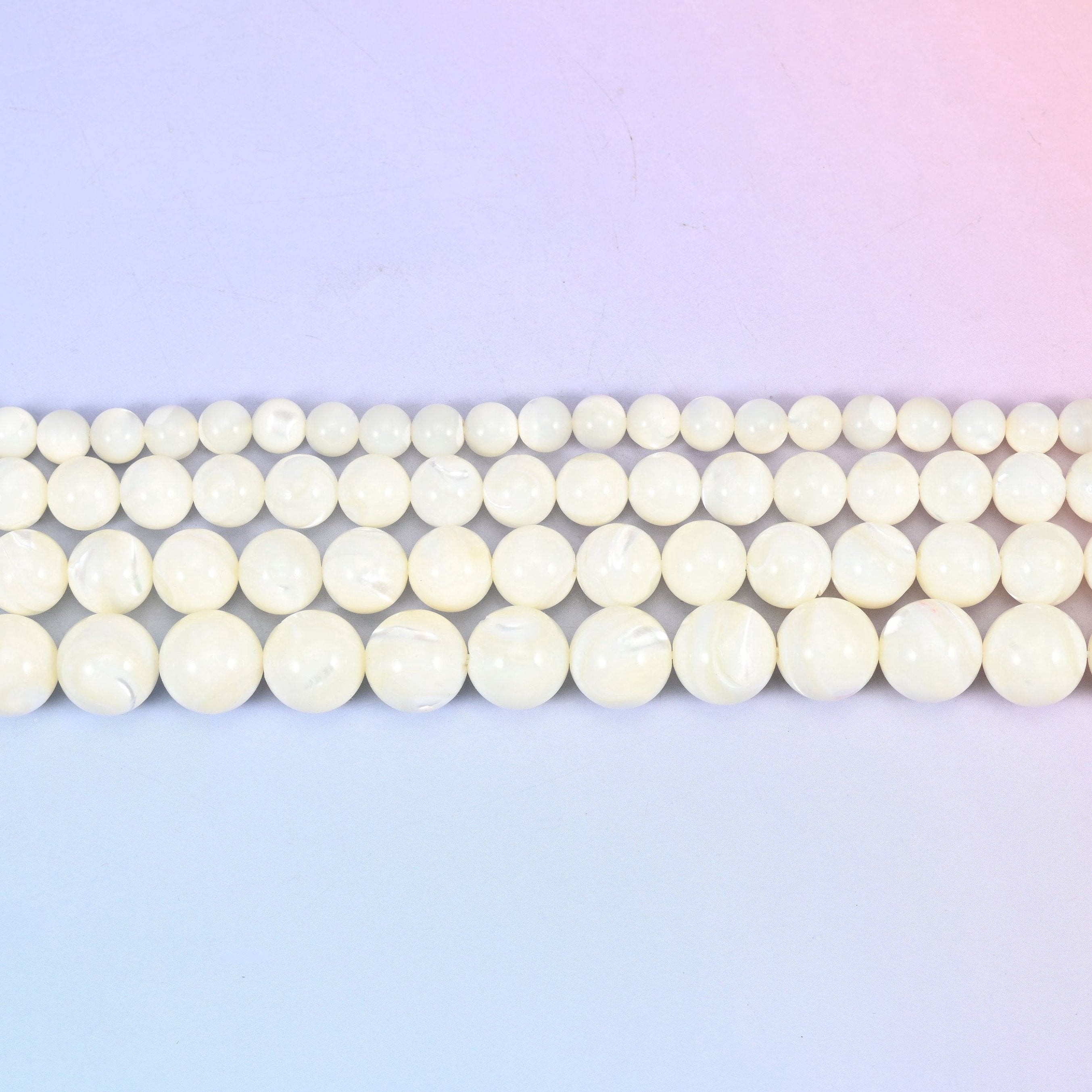 White trochus shell round beads in creamy ivory with faint pearly growth lines