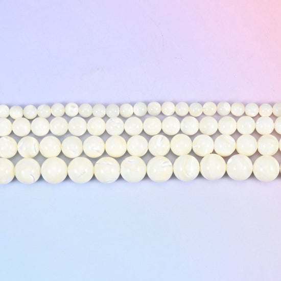 White trochus shell round beads in creamy ivory with faint pearly growth lines