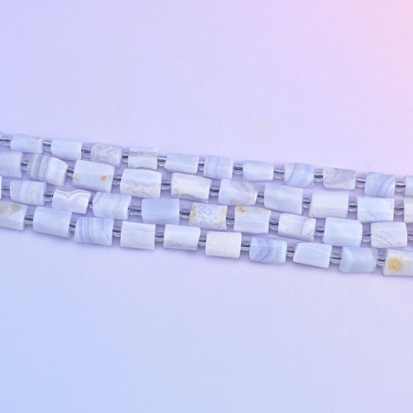 Blue Lace Agate faceted tube beads in a soft blue color.