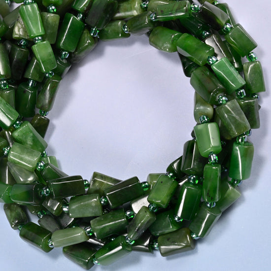 Canadian Green Jade faceted tube beads coiled into a ring, colour running from solid dark green to pale sage from bead to bead