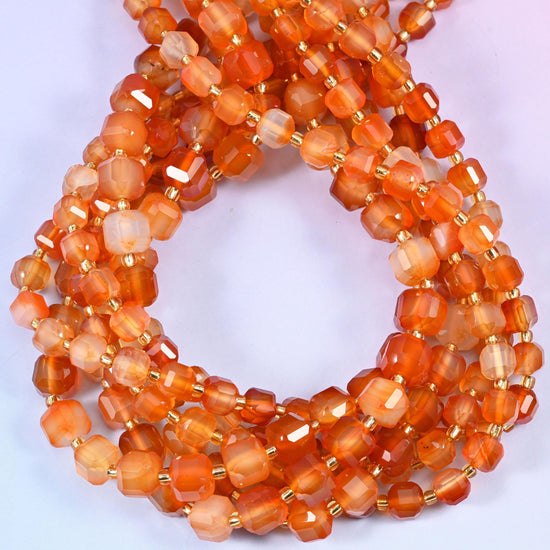 Warm apricot through to burnt amber, translucent enough that light travels through the stone, with milky white and pale honey banding cutting across some beads.