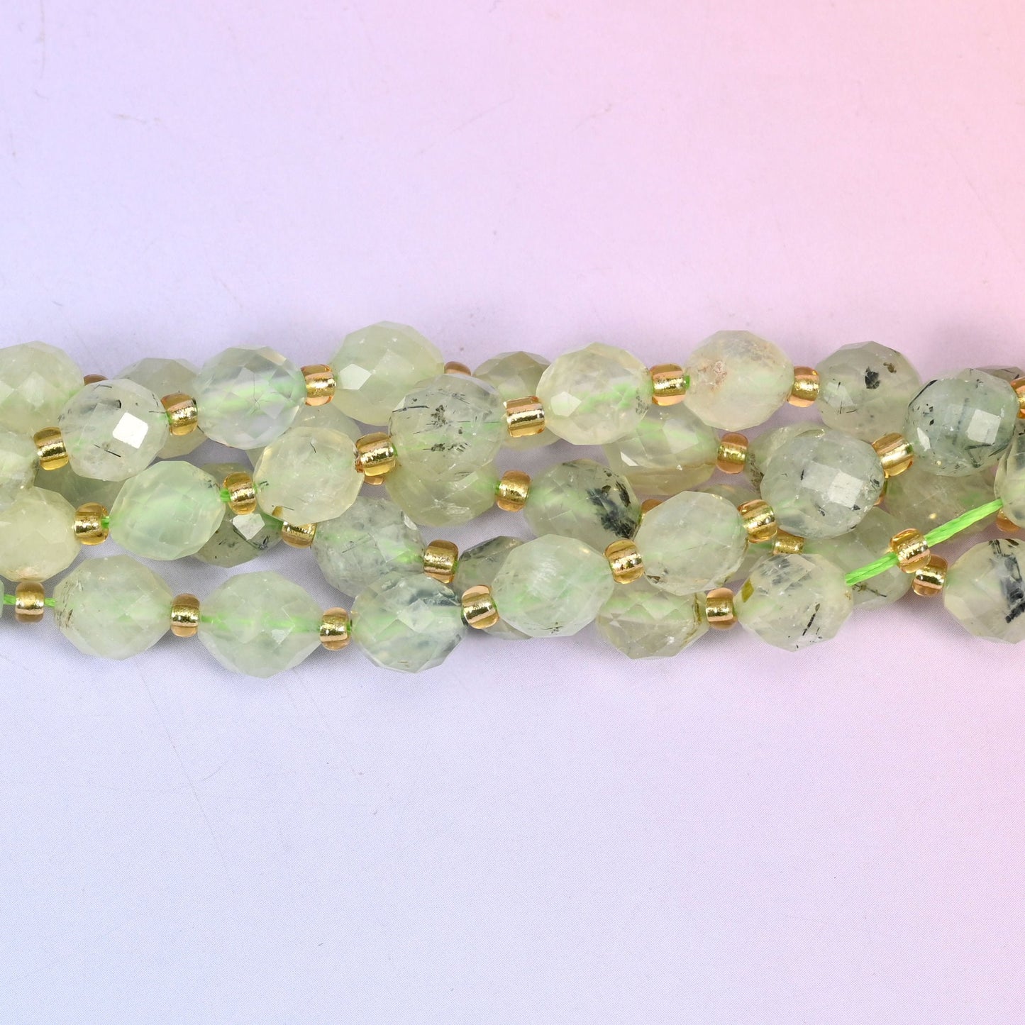 Prehnite faceted rice barrel beads with a milky glow and fine dark inclusions