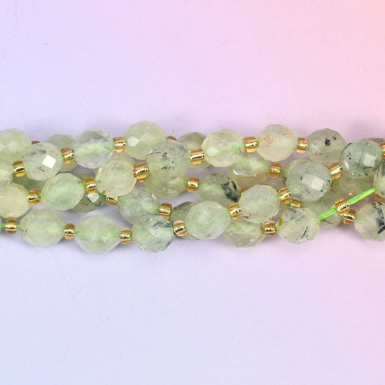 Prehnite faceted rice barrel beads with a milky glow and fine dark inclusions