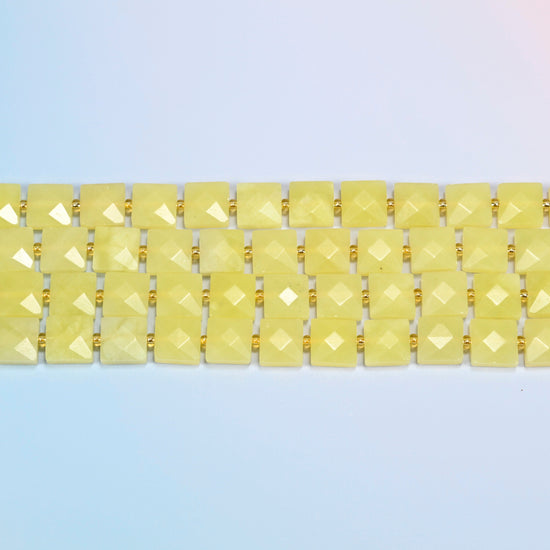 Several strands of Lemon Jade faceted flat square beads laid in straight rows
