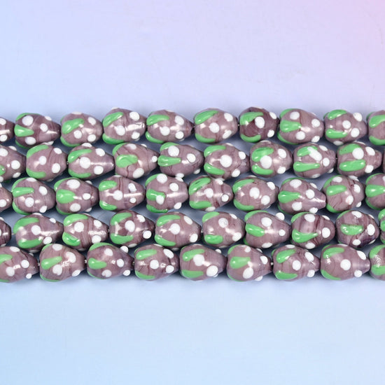 Purple White Dots Strawberry Glass Beads in muted mauve-purple with a bright green leaf band
