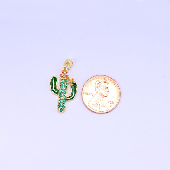 A little saguaro in green enamel with a pavé of green zircon running up the body and a coral blossom perched on one arm — desert kitsch done properly, in gold plated brass.