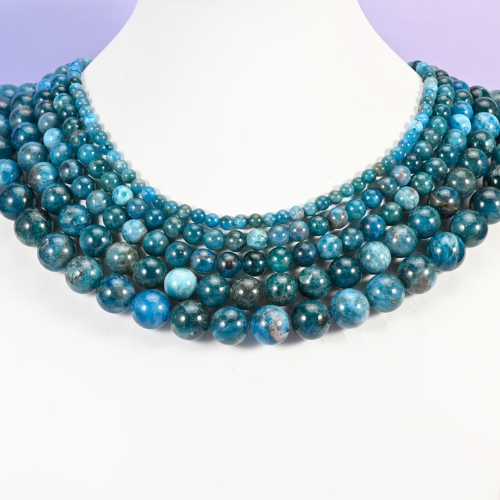 Blue Apatite round beads looped around a white neck display form, strands in 6mm, 8mm and 10mm together