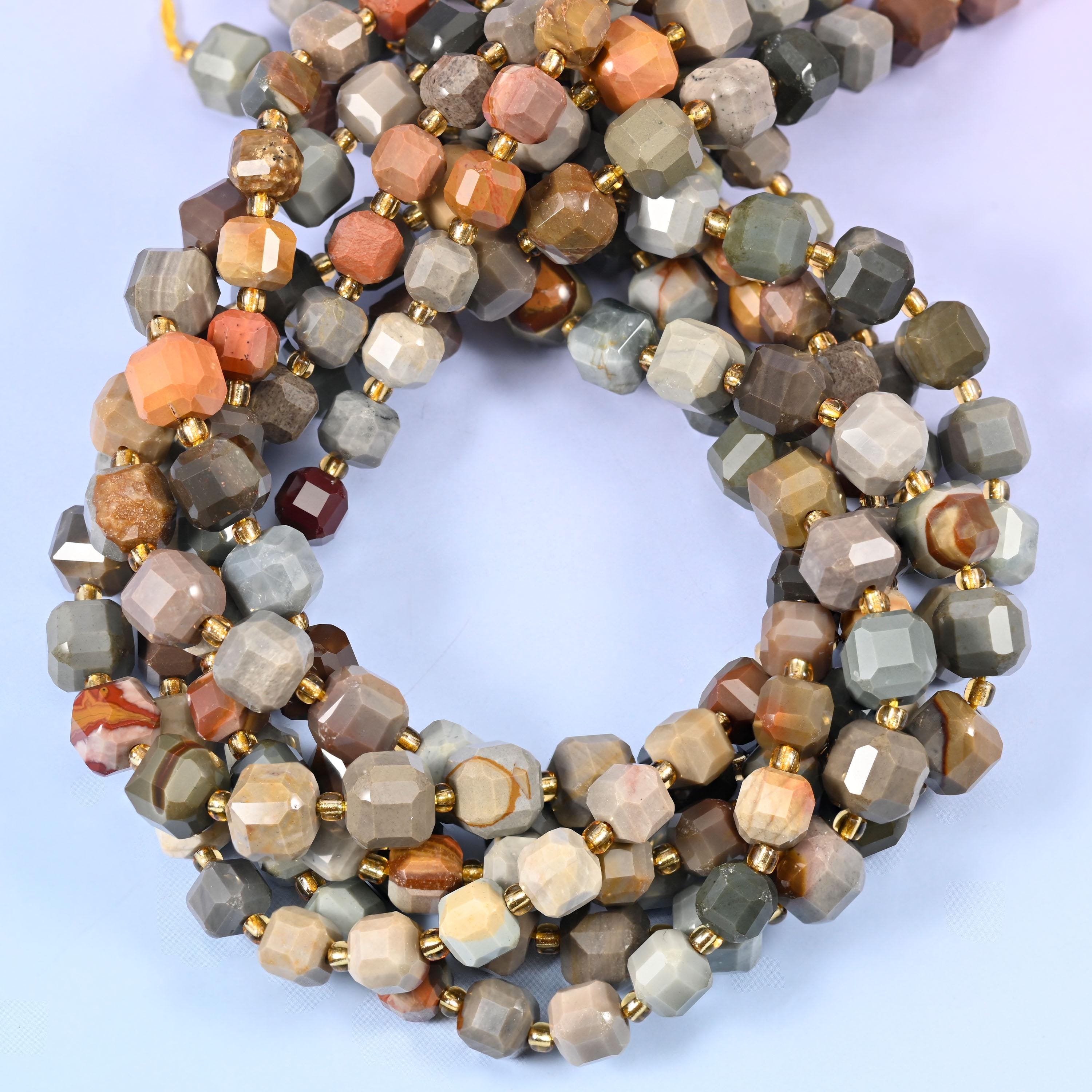 Warm greys, taupe and cream shot through with flashes of coral-orange, every cube faceted at the corners so the desert-toned banding catches light from several angles at once.
