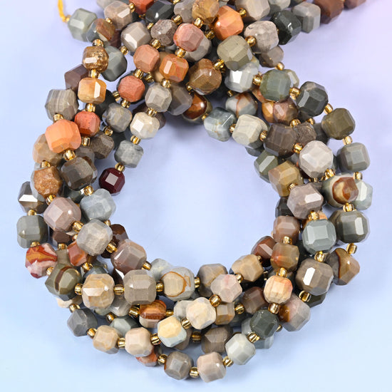 Warm greys, taupe and cream shot through with flashes of coral-orange, every cube faceted at the corners so the desert-toned banding catches light from several angles at once.