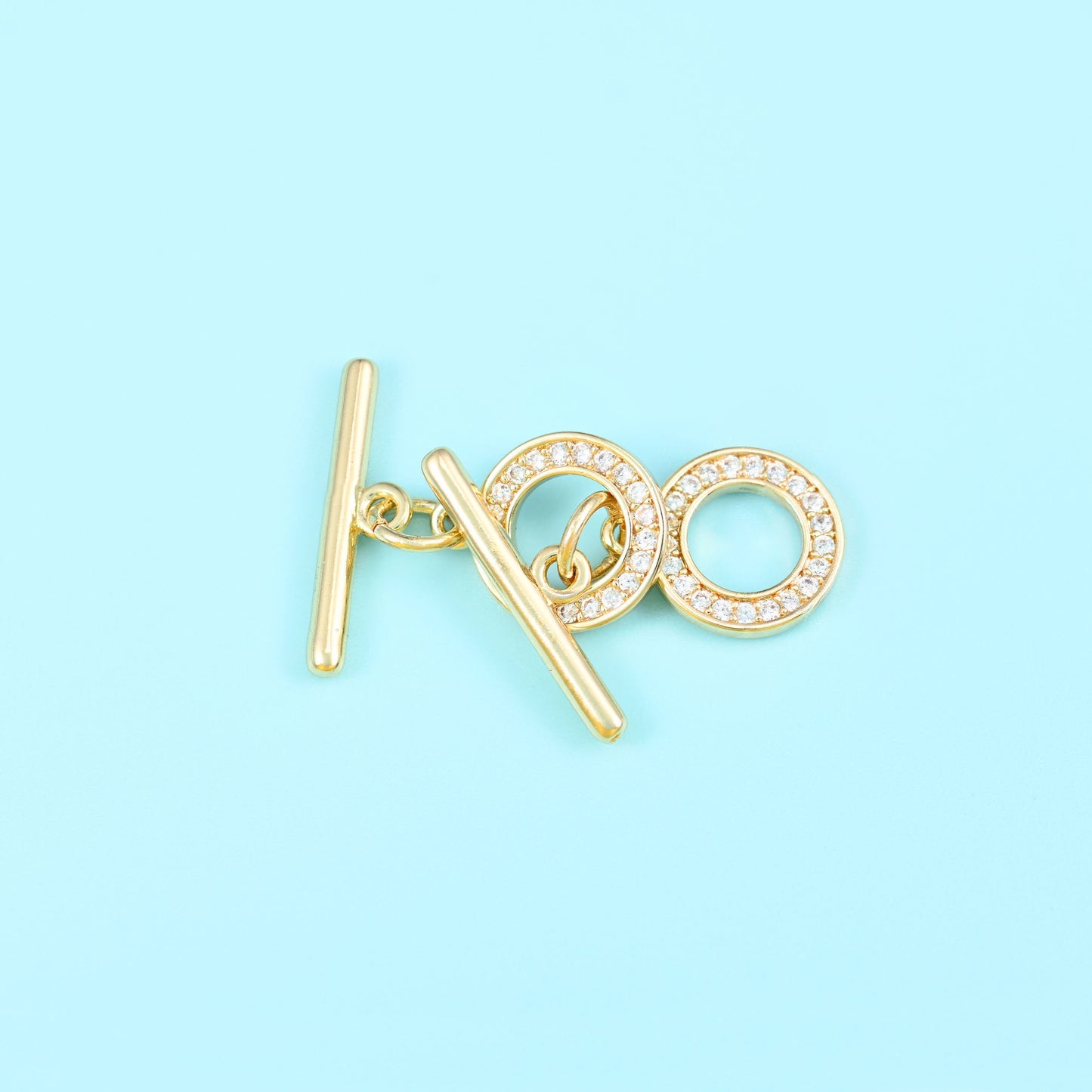 Round toggle clasp with 18K gold filled finish and set zircon stones
