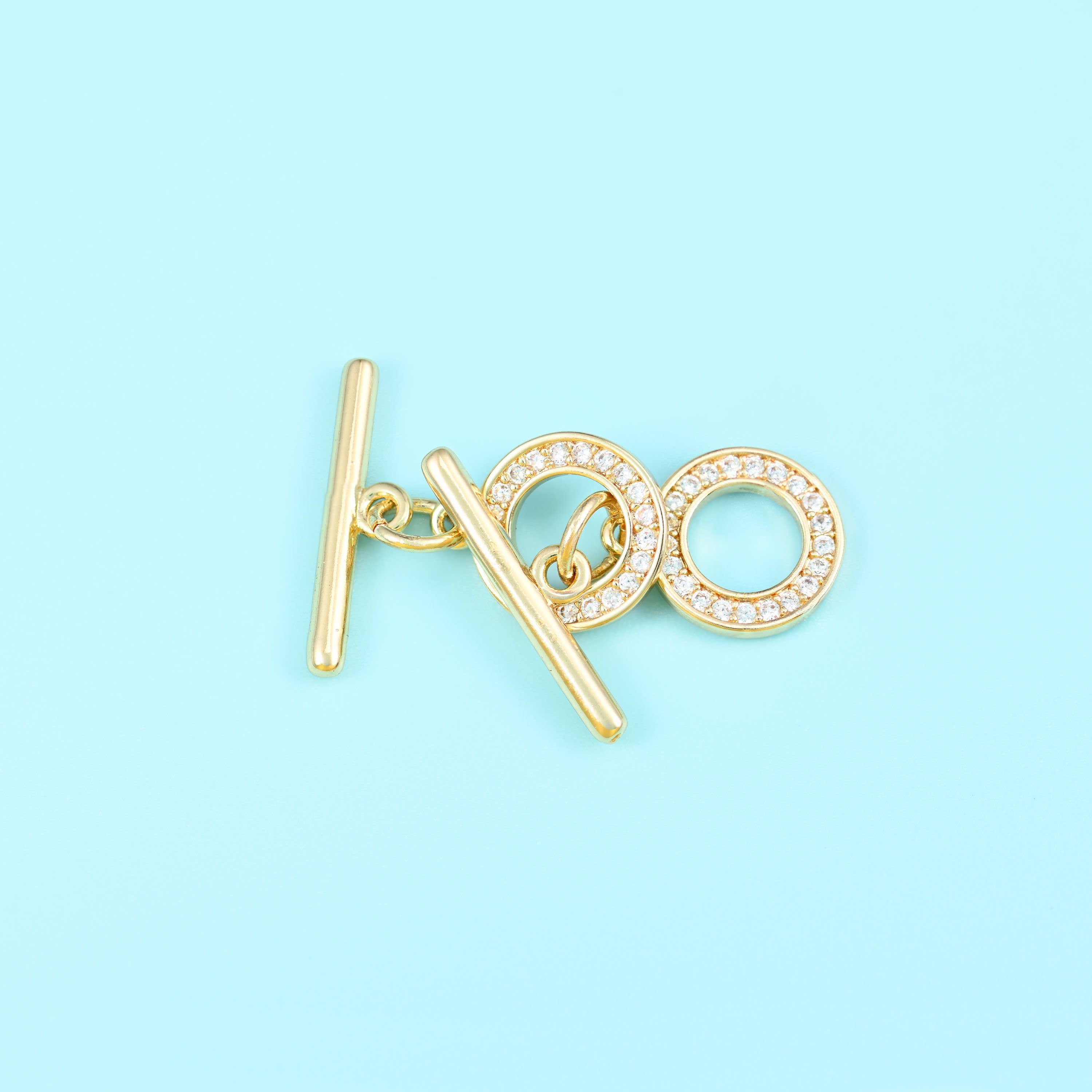 Round toggle clasp with 18K gold filled finish and set zircon stones