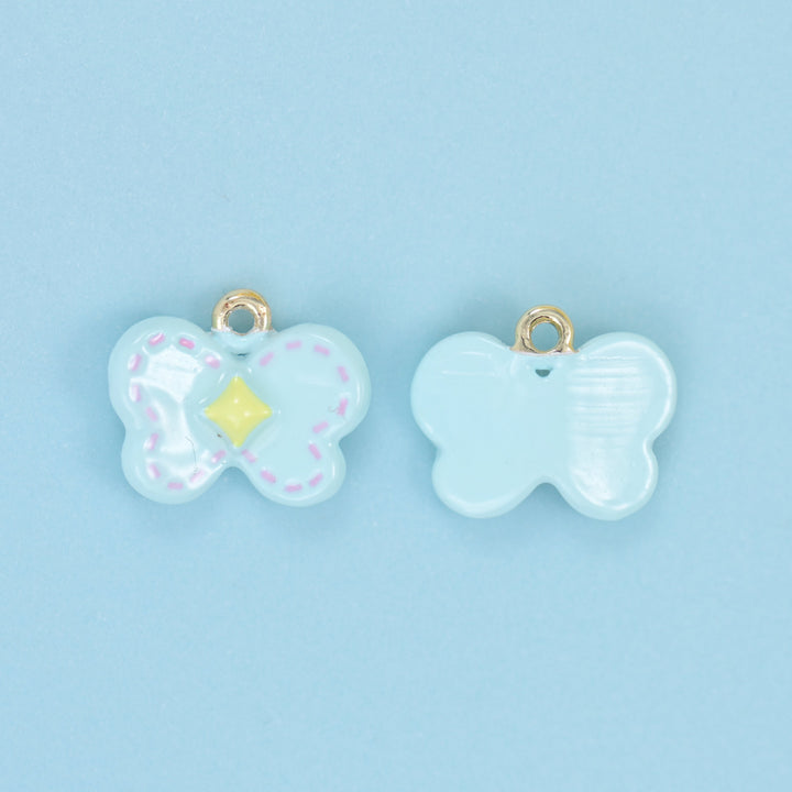 Light blue butterfly charms shown front and back, dotted wing outline and a yellow centre diamond.