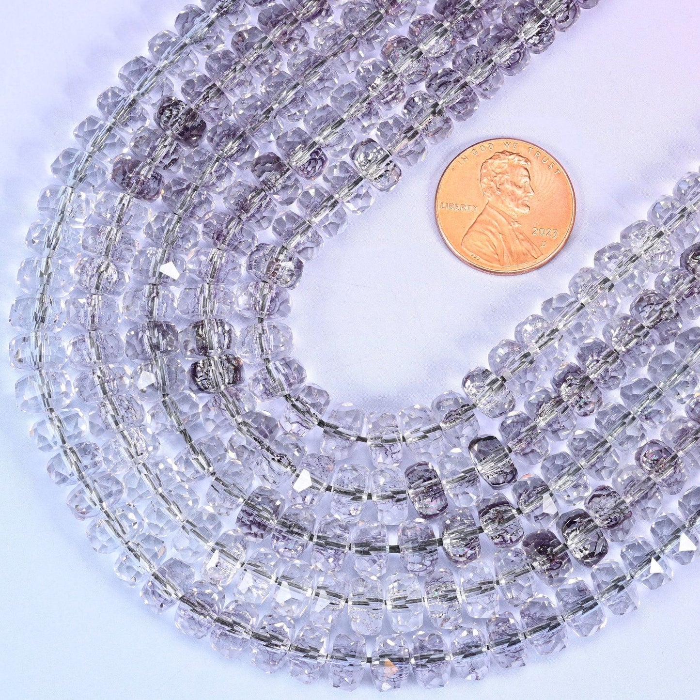 Faceted rondelle cut transparent light purple glass beads