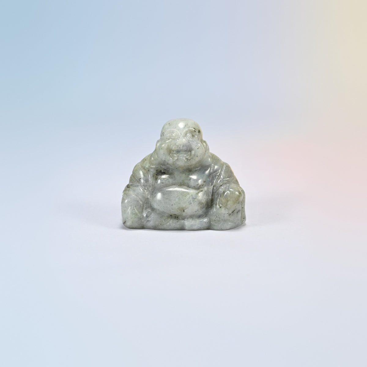 One white labradorite laughing Buddha crystal carving, light gray natural stone with dark speckles