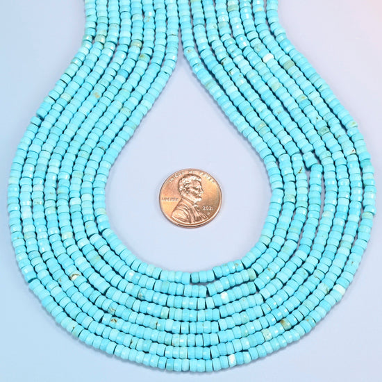 Dyed blue howlite faceted heishi disc strands formed into a teardrop loop around a US penny for scale
