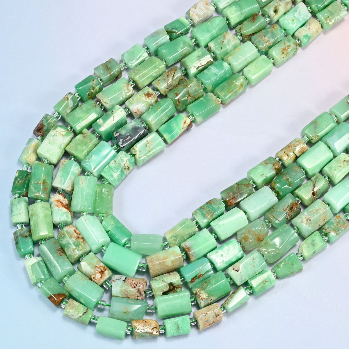 Australian jade faceted tube beads in several strands curved into a wide U, mint green stone with tan and brown matrix