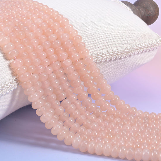 Soft Pink Dyed Jade smooth rondelle beads in an even blush pink with a faint warm peach cast