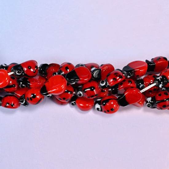 Red ladybug glass beads for garden-theme stretch bracelets and charm necklaces.