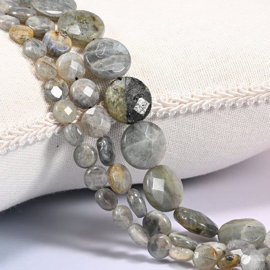 Gray Labradorite faceted coin beads draped in a soft curve, flat discs in light silver gray and cream