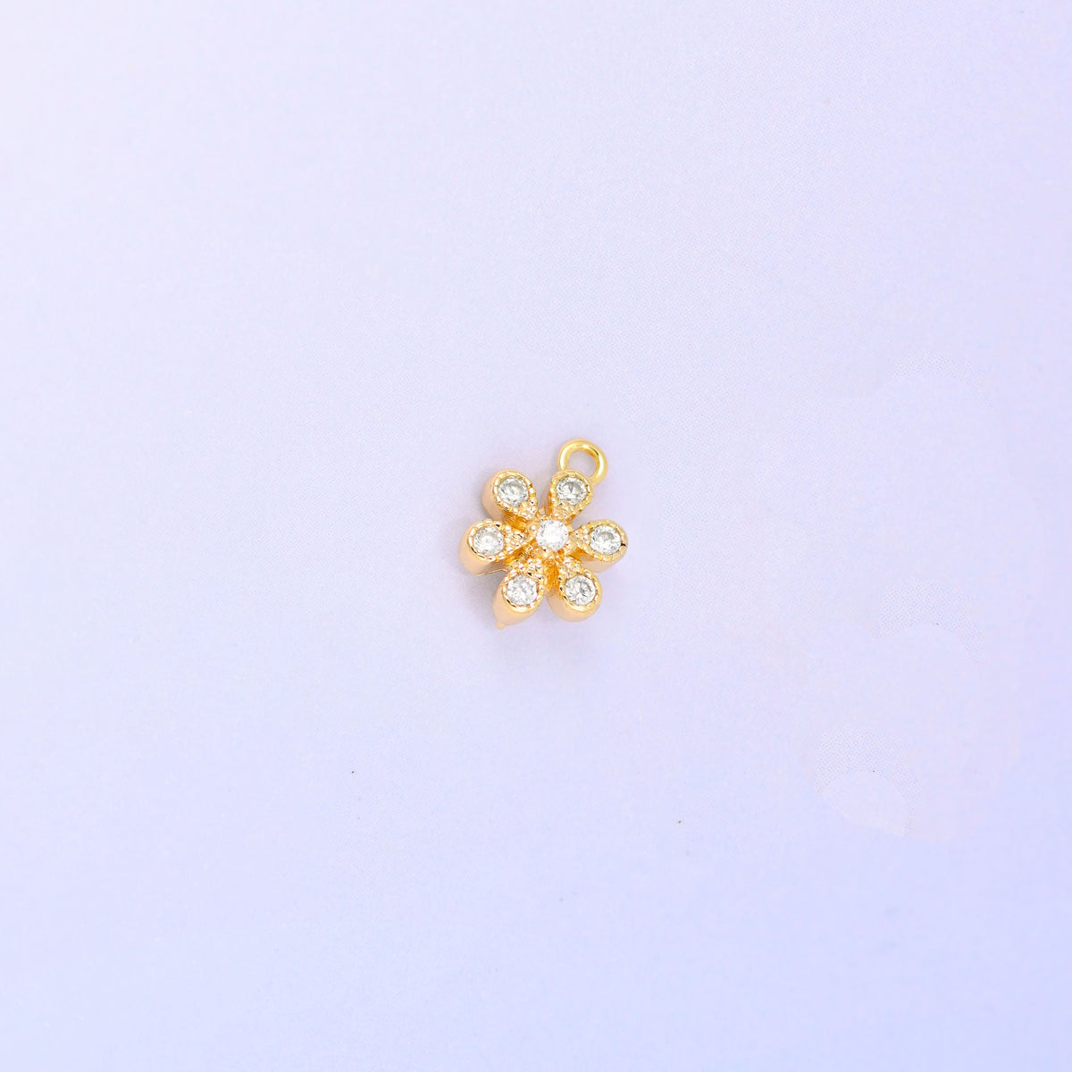 Small gold charms, a single 18K gold plated flower charm with clear cubic zirconia