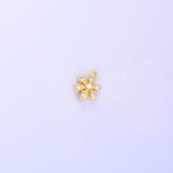 Small gold charms, a single 18K gold plated flower charm with clear cubic zirconia