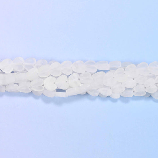 Matte clear quartz flat heart beads in frosted white, translucent enough for light to pass through but with no shine.