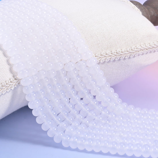 White Dyed Jade smooth rondelle beads in a soft, translucent white with a polished finish