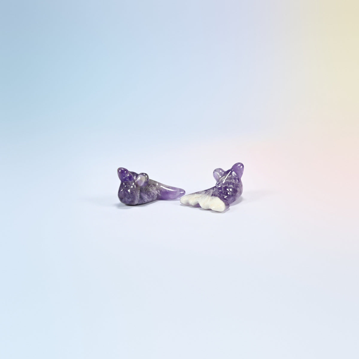 Two 1.5 inch natural amethyst goldfish carvings, purple and white banding